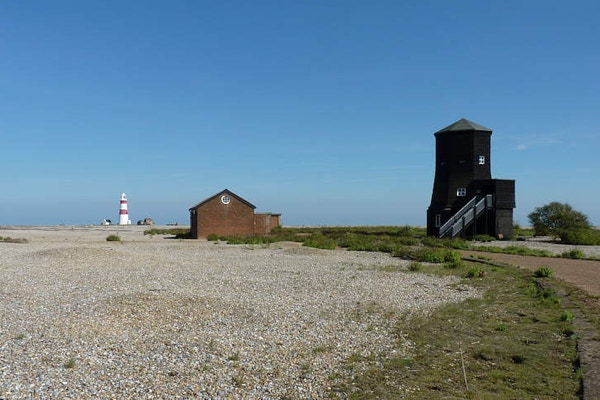 The Orfordness lighthouse and Black Beacon seen from on Orford Ness